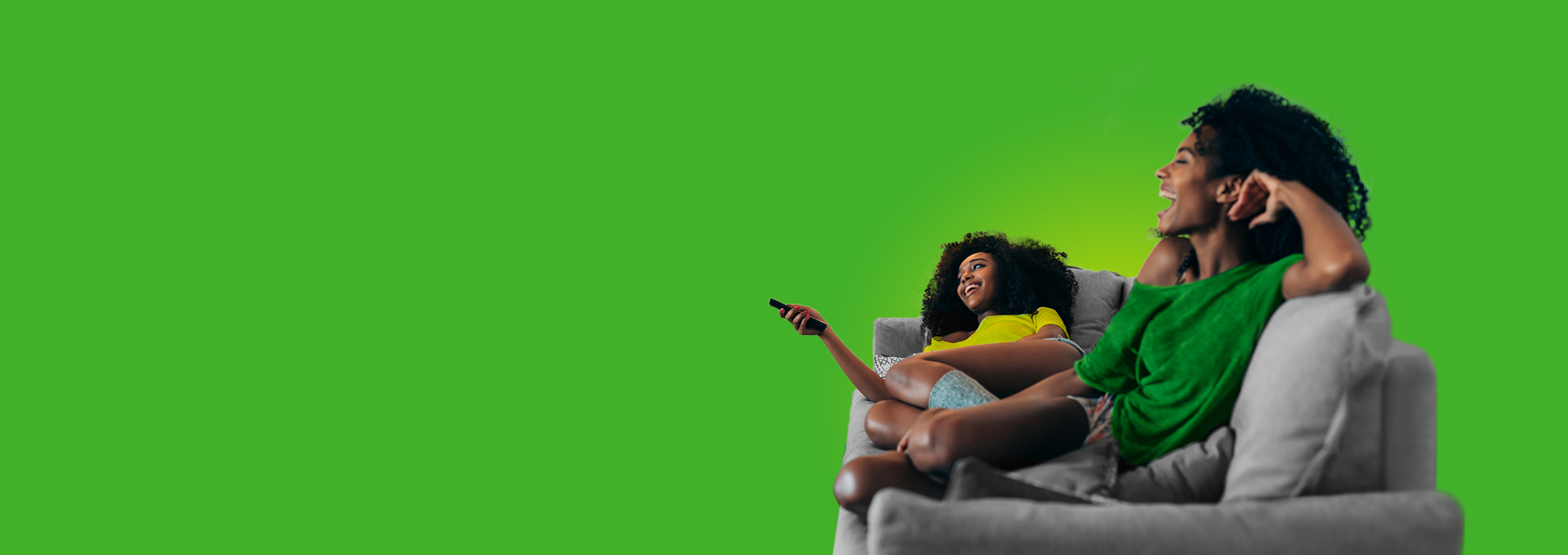 Two woman on the couch watching television