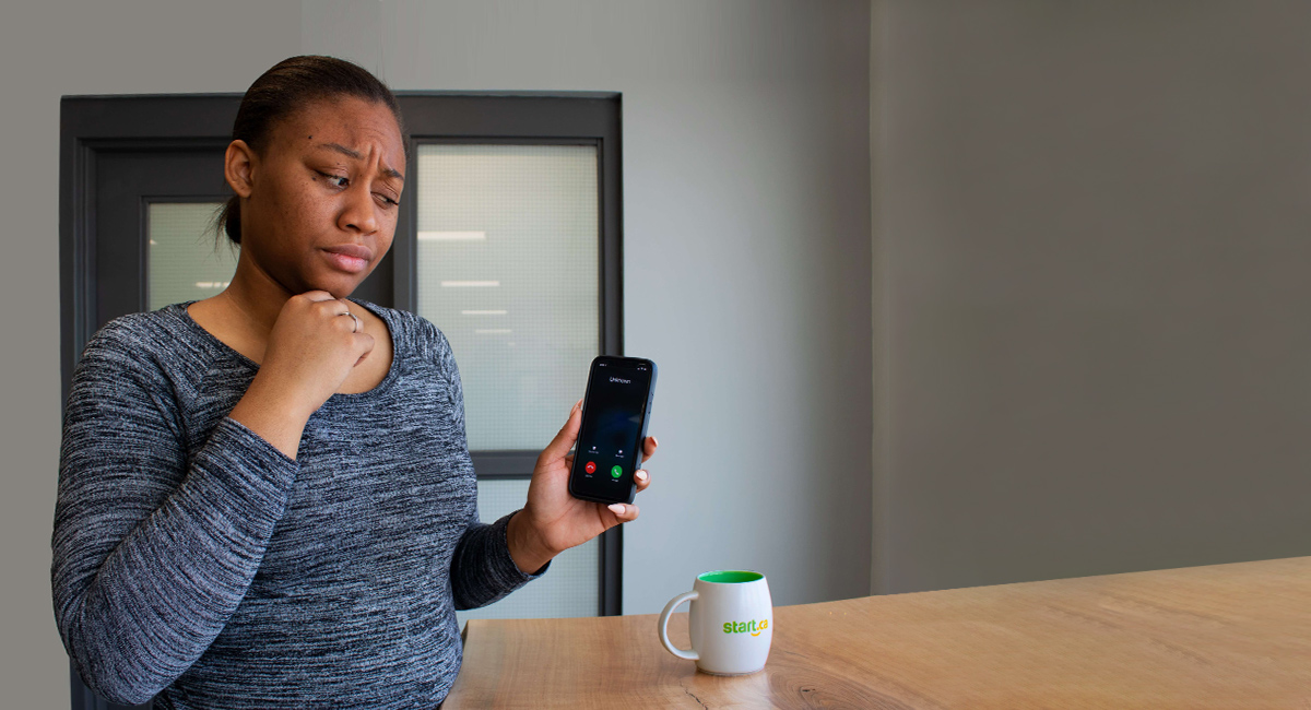 woman staring suspiciously at her phone