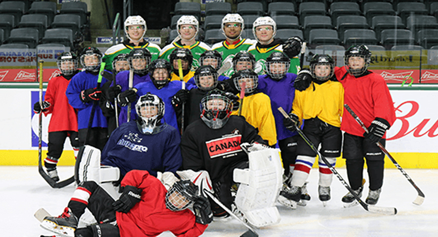 Young hockey players pose with members of the London Knights