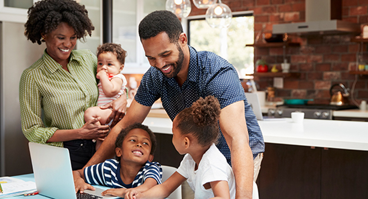 family gathered around a laptop