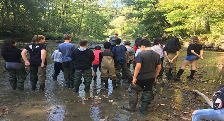 kids standing in creek