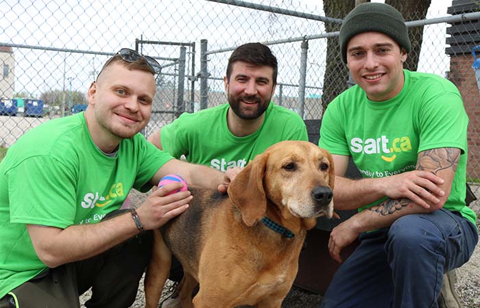 Staff with a dog outside of the London Humane Society