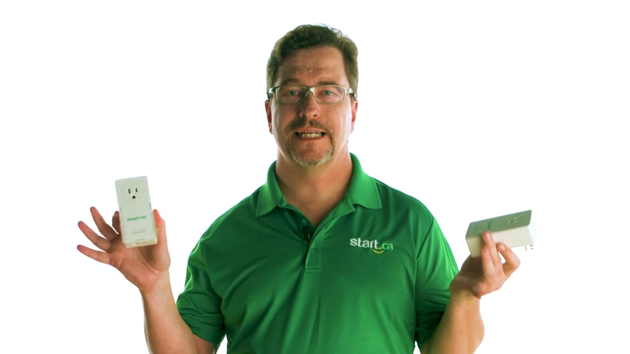 Man holding two PLC adapters in each hand to demonstrate the differences